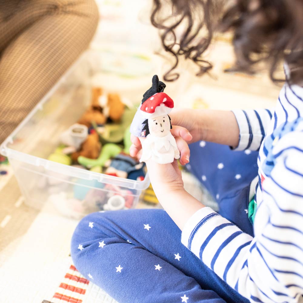 up early intervention clinic current clients child playing with finger puppets